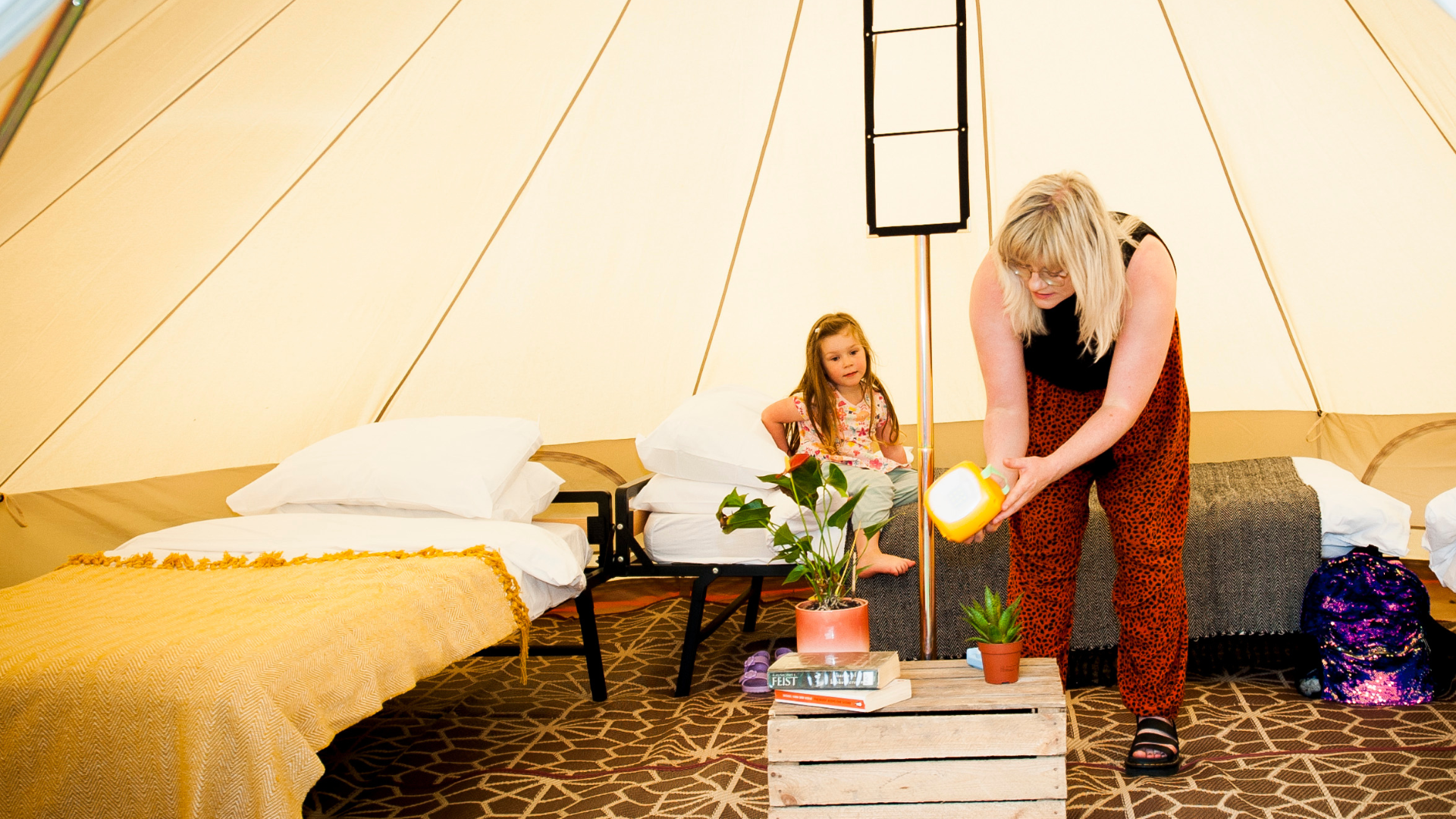 Mother & child inside a cosy furnished bell tent